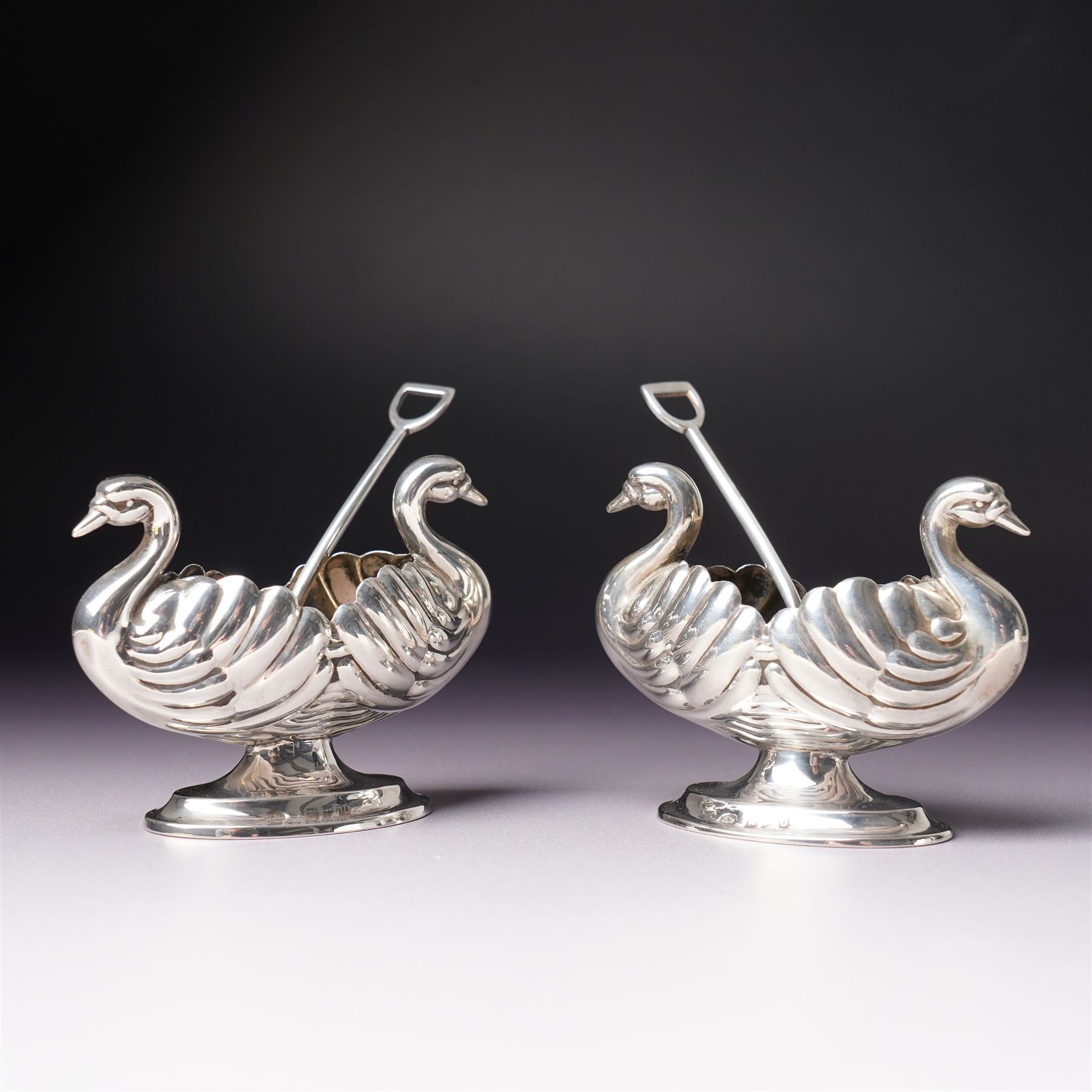 Pair of Victorian silver double headed Swan shape salts L7cm Chester 1897 Maker Florence Warden together with a pair of plated spade shape spoons 