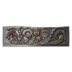 18th century oak panel carved with a cherubs head in high relief among fruit and foliage, W75cm