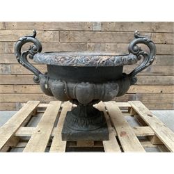 Victorian design ornate cast iron centrepiece urn, featuring two handles, raised on footed base