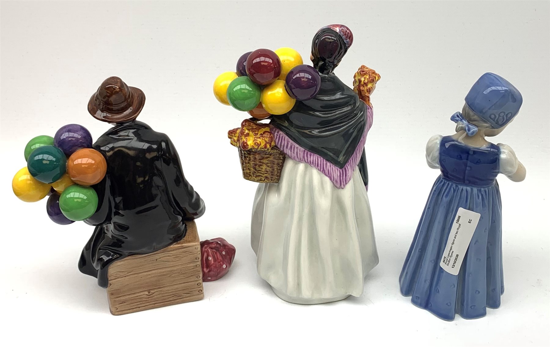 Royal Copenhagen figure of a young girl holding a doll and two Royal Doulton figures: Biddy Penny Farthing and The Balloon Man (3)