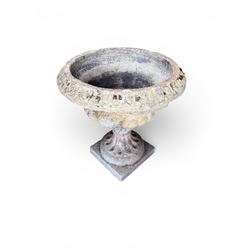 19th century terracotta campana shape urn planter, egg-and-dart moulded rim over a cherub-mask and gadrooned underbelly, turned pedestal and socle on square base