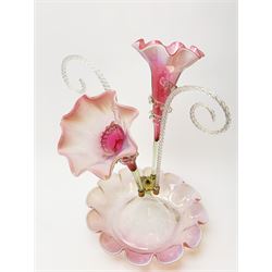 A Victorian cranberry and Vaseline glass epergne, the frilled bowl supporting two frilled trumpets and two canes, H41cm. 