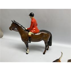 Beswick hunting group, comprising huntswoman on grey horse no 1730, huntsman on brown horse no 1501, two seated fox figures no 1748 and seven fox hounds, all with printed marks beneath (11)
