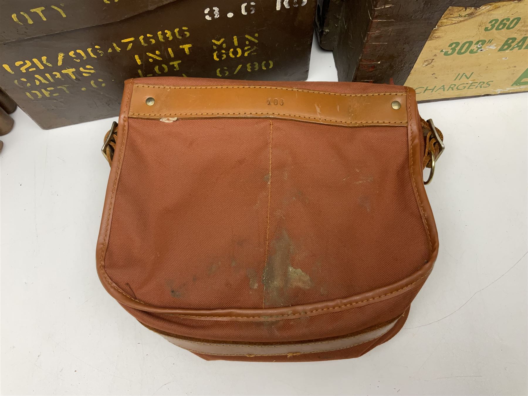 Miscellaneous shooting accessories - W.J. Bowman & Sons clay pigeon launcher; two leather cartridge belts; three cartridge bags; two canvas/leather game bags; and two metal/wooden cartridge boxes