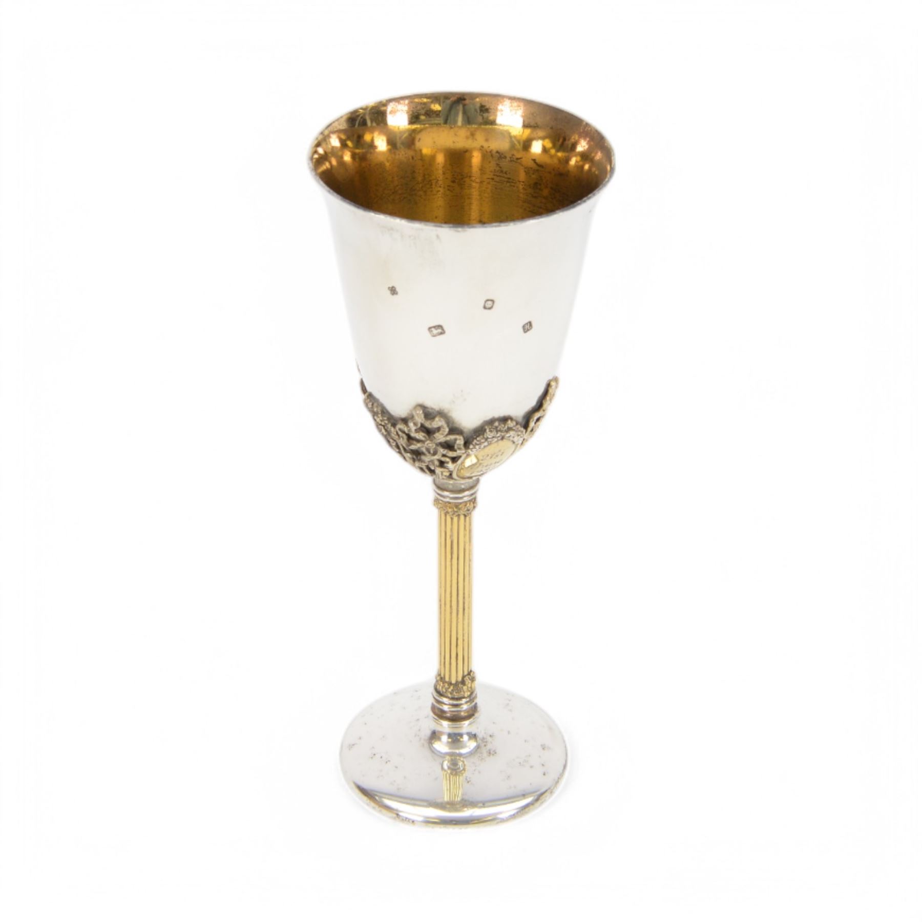 Late 20th century silver goblet, commemorating the birth of HRH Prince William of Wales 21st June 1982, the goblet of plain form, with parcel gilt daffodils and ribbons atop a parcel gilt column stem upon a circular foot, hallmarked St James House Company, London 1982, H19.5cm