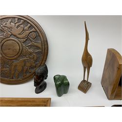 Pair of elephant bookends, carved wall plaque of a bird amongst branches, twin handled tray with inlaid decoration, book slide, carved head, circular carving decorated with rhinos, and other carved African ornaments etc