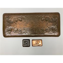 Arts and Crafts Newlyn School copper tray, of rectangular form with rounded corners, with embossed decoration of four stylised fish surrounding a central shaped and vacant panel against a lightly planished ground, stamped Newlyn, L58.5cm, W24.5cm, together with two small Arts and Crafts Newlyn copper pin dishes, the first example of rectangular form decorated with a galleon, L10.5cm, the second of square form decorated with a fish, L8cm, each stamped Newlyn, (3)
