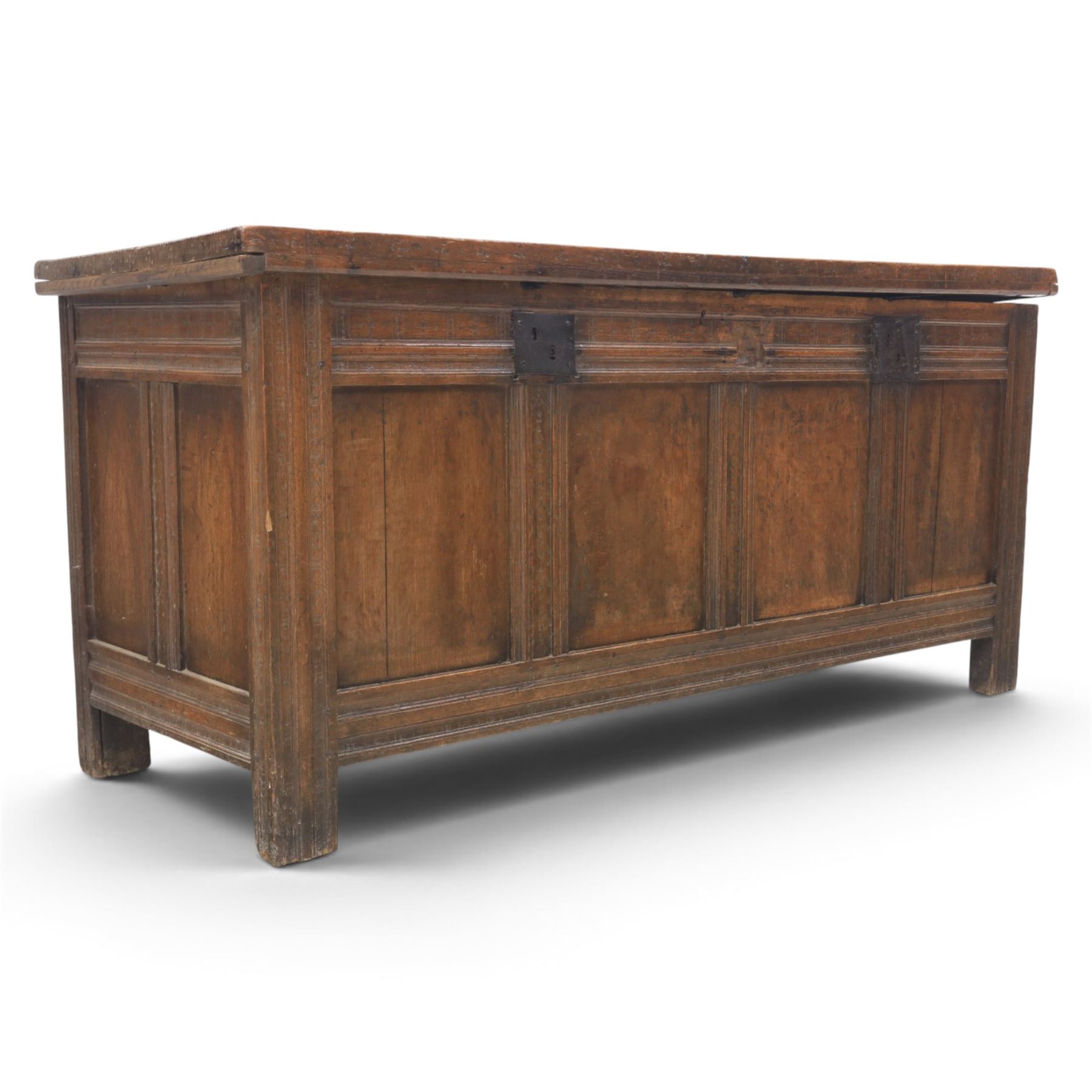 Large 17th century oak coffer, plank top with moulded edge, four panel front with channel moulded uprights, retaining original wrought iron strap hinges and central lock plate, panelled ends, raised on stile supports