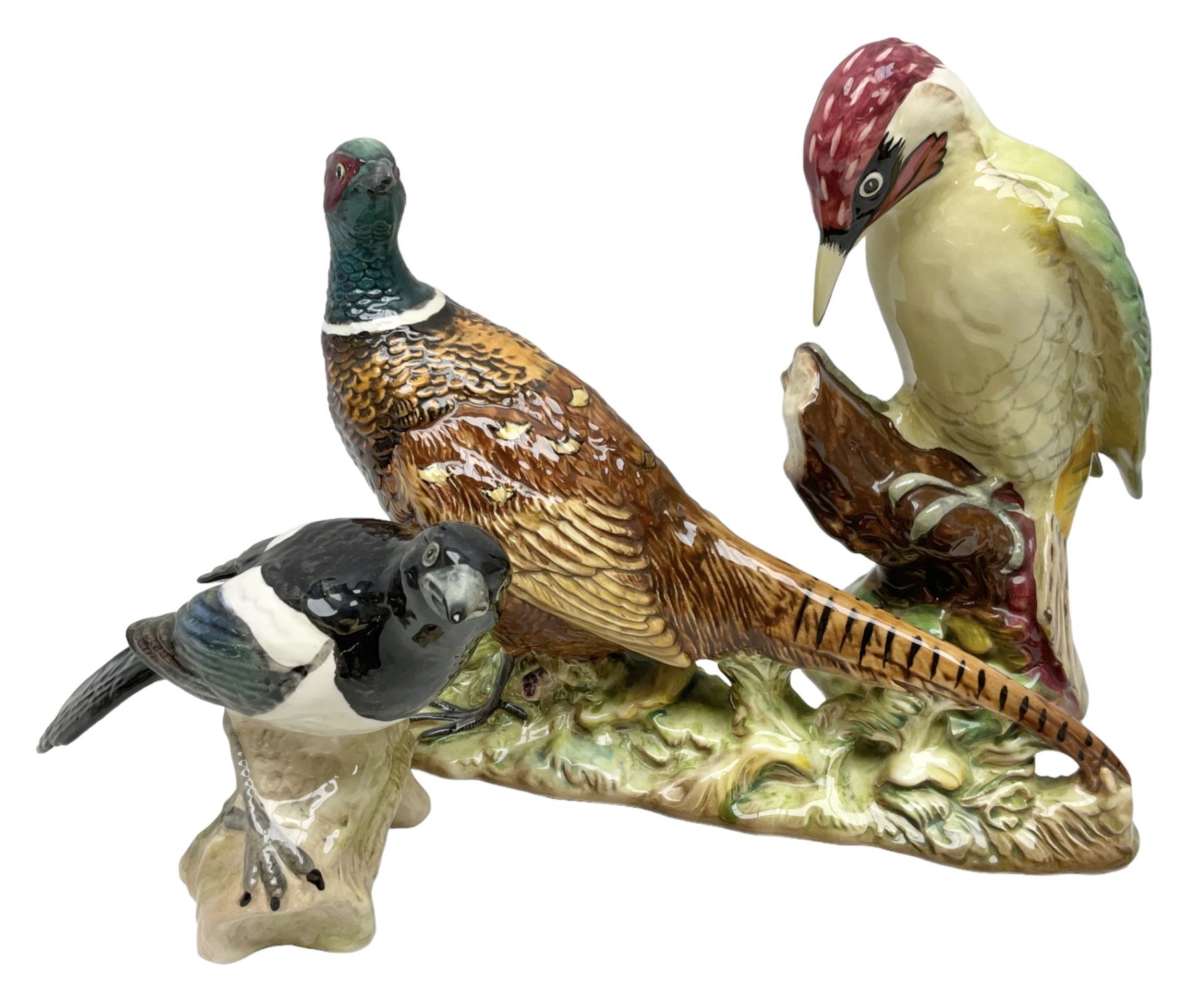 Three Beswick figures of birds, comprising pheasant no 1225, magpie no 2305 and woodpecker 1218, all with impressed marks beneath, tallest H22cm