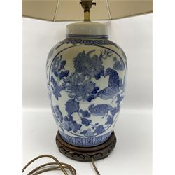 Chinese blue and white table lamp of baluster form, decorated with birds and floral displays, on hardwood base with shade, H78cm