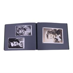 Collection of photographs and postcards, mostly depicting 1940s film stars, including some autographed examples and some with printed signatures, together with a collection of Shirley Temple  promotional photographs,1930s autograph album and postcards of the Royal Family