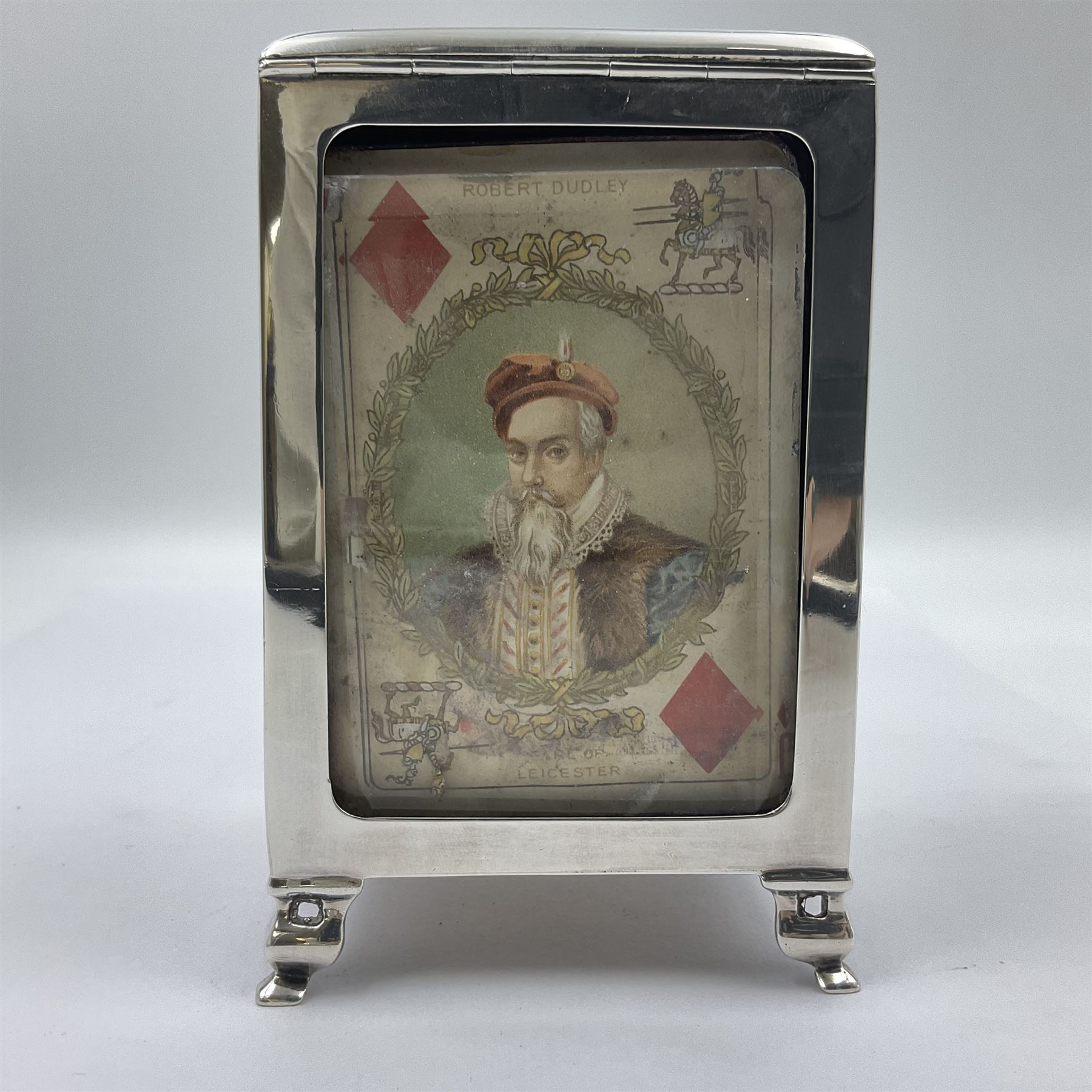 Edwardian silver mounted playing card case, hallmarked William Harrison Walter, Birmingham 1903, the sides each with a period playing card set behind a bevelled glass panel, the hinged cover with later engraving 'Presented to Norman T Crombie Esq by the officers & men of the 31st WR Detachment for services rendered 1917-1918', with red leather lined interior, the three compartments upon a sprung base and containing two later wooden Whist markers, case H12.5cm