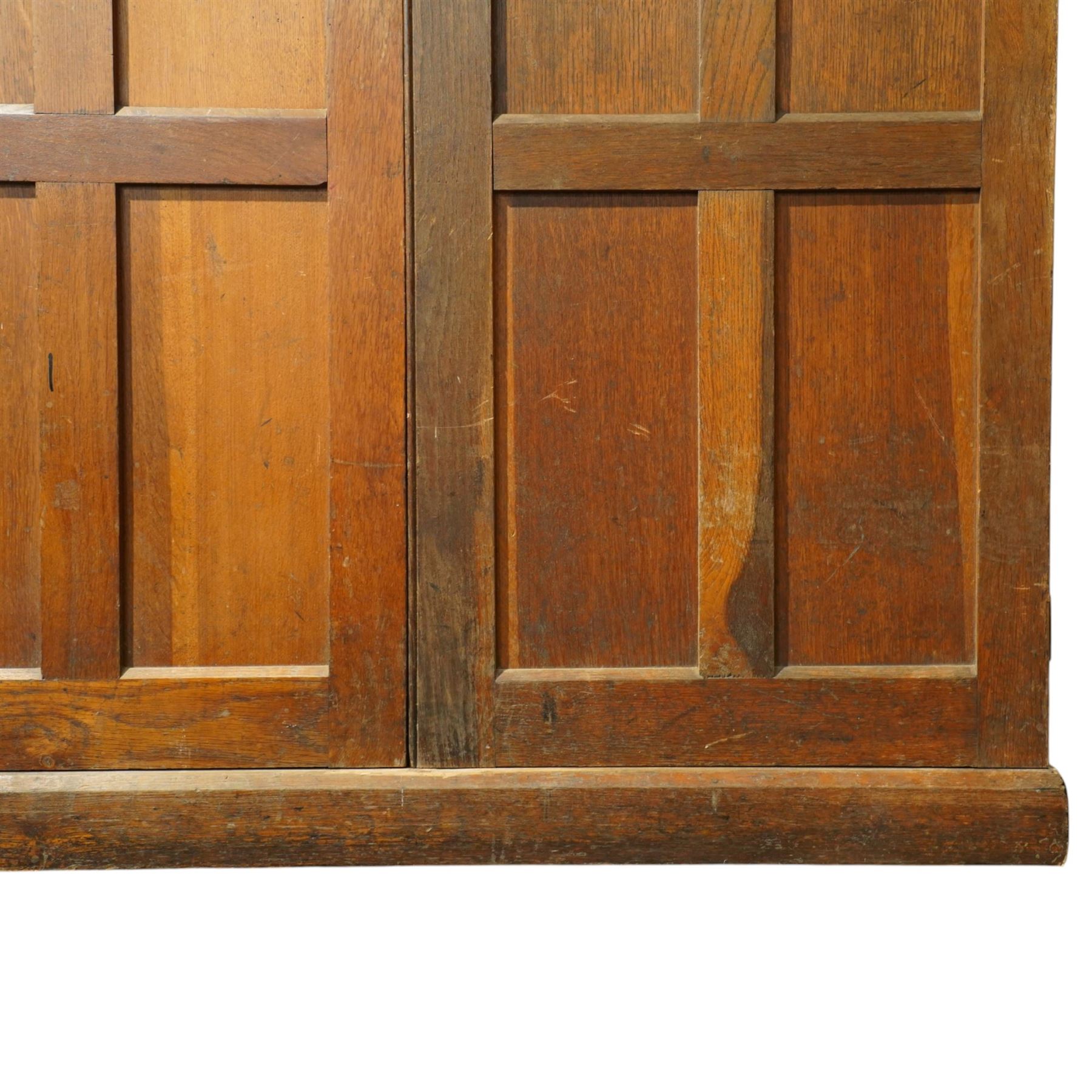 Early 20th century Arts and Crafts oak housekeeper’s cupboard, moulded cornice above pair of panelled doors enclosing a shelved interior, on plinth base