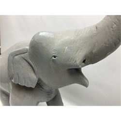 Composite figure of an elephant, painted grey, upon white base, L45cm H65cm