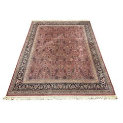 Large Persian design red ground carpet, the field decorated with repeating tree of life design, multi-band border decorated with stylised flower heads