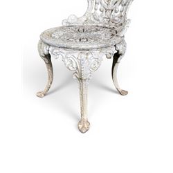 Pair of white painted cast metal garden chairs, ornate reclined backs, circular pierced seats on cabriole legs
