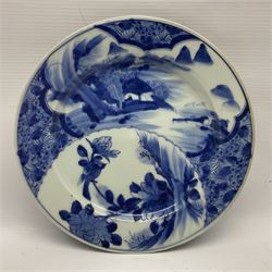 Japanese Meiji period Arita blue and white plate, of circular form, painted with riverside landscape and bird upon flowering branch, with character mark beneath, D24.5cm, together with two 18th century Chinese blue and white plates, each painted with floral design, each approximately D22.5cm