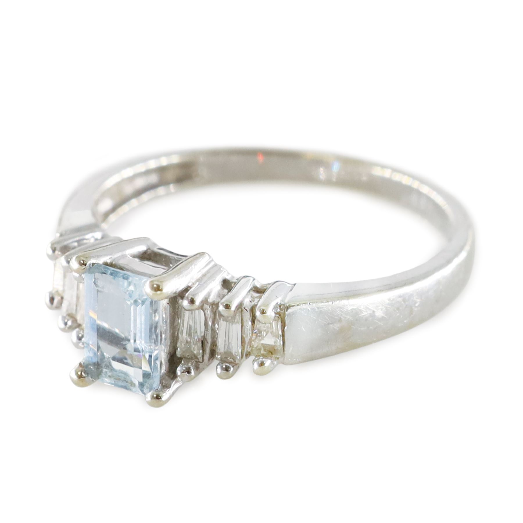 10ct white gold aquamarine and diamond ring, single octagonal cut aquamarine of approx 0.45 carat, with three tapered baguette cut diamonds set either side, stamped