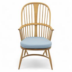 Ercol - ‘Chairmakers’ armchair, of traditional Windsor form in light ash, featuring a hoop back with four spindles and central splat, curved arms and turned supports, dished seat with upholstered blue cushion