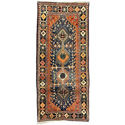 Persian blue ground rug, field decorated with four pole medallions with surrounding repeating bird motifs, coral spandrels with flowerheads, guarded border decorated with repeating geometric lozenges