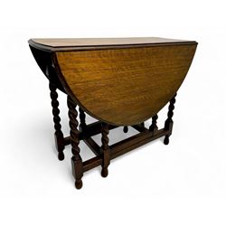 Early 20th century oak gateleg table, oval top with drop leaves supported by barley twist swing supports, united by plain stretchers, on turned feet (W119cm, D92cm, H77cm);