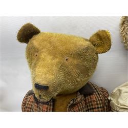 Two early 20th century straw filled jointed teddy bears, first example wearing a tweed jacket bearing Geoffrey Saville label, with leather padded paws and ears, horizontally stitched nose and humpback; second example with applied eyes, vertically stitched nose and faux leather paw pads, both with growler mechanisms, tallest H74cm 