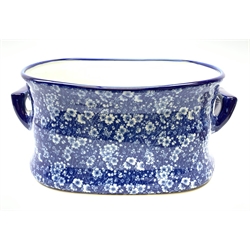 A modern blue and white transfer printed prunus blossom pattern footbath, with twin carry handles, L41.5cm.  