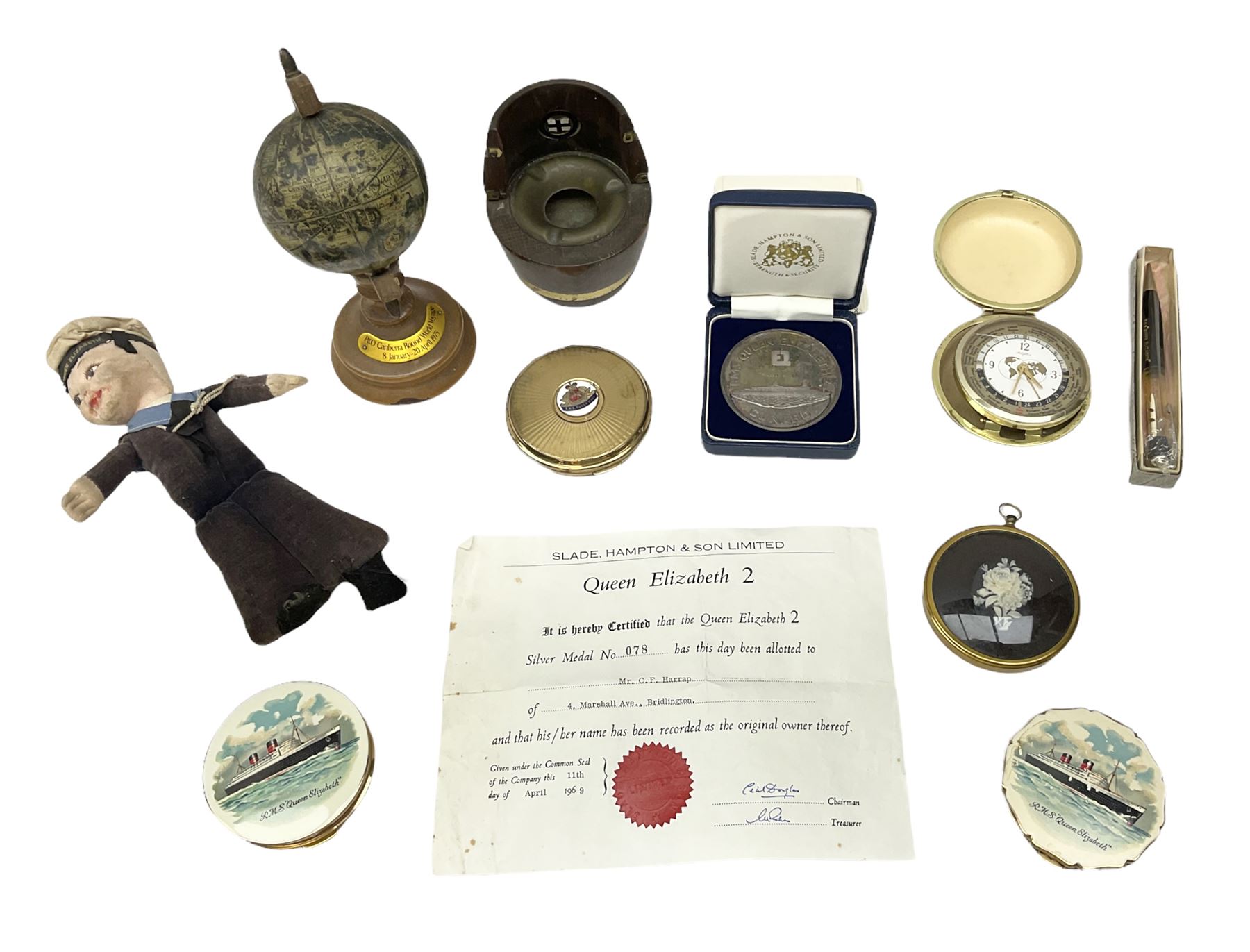 Silver 1969 Cunard RMS Queen Elizabeth maiden voyage commemorative medallion, in original Slade, Hampton & Son case with certificate, two Stratton R.M.S Queen Elizabeth mirror compacts, Stratton R.M.S Queen Mary compact, mid 20th century P&O Canberra Round World Voyage miniature globe, S.S Oriana ash tray modelled as a barrel, Norah Wellings sailor doll, and other maritime and shipping memorabilia 