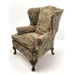 Matched pair early 20th century Queen Anne style wingback armchairs, walnut framed, sprung seats with seat cushions upholstered in needle work cover, shell carved cabriole front feet