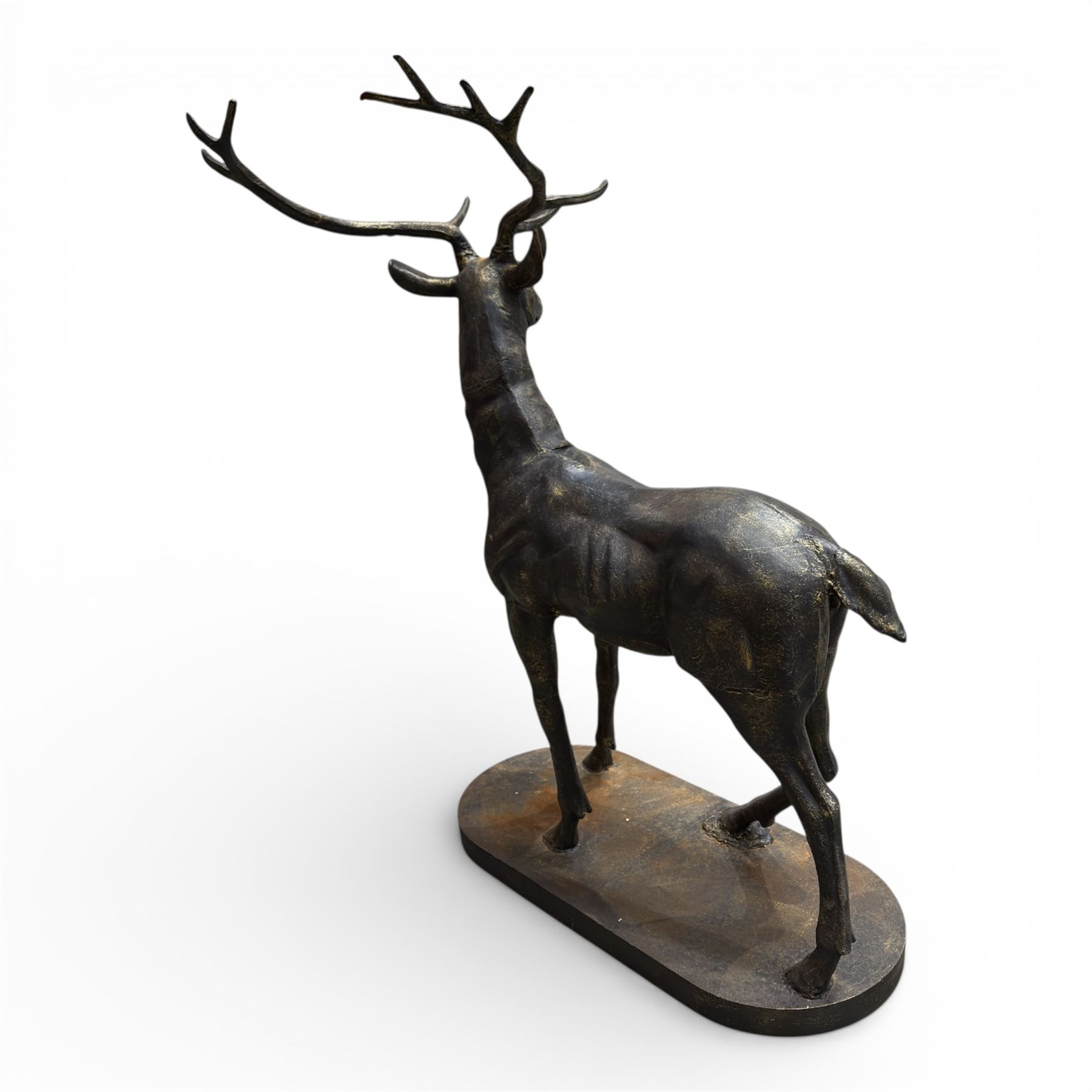 Pair of life-size cast iron garden or home stags, modelled standing upon oval plinths