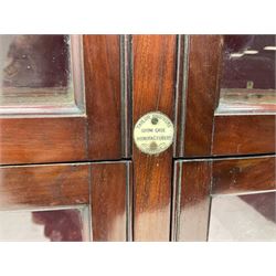 Late Victorian mahogany former gun cabinet to accommodate twelve guns, the pair of glazed doors with knob handles and glazed panels over, opening to reveal a baize lined interior; inset ivorene plaque for Taylor brothers Showcase manufacturers; L91cm H134cm D39cm
