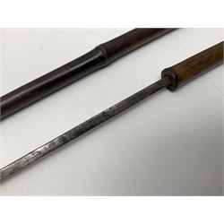 Early 20th century bamboo sword stick with 39cm oblong section blade L85cm overall; and two malacca cane swagger sticks, one with white metal mounts the other with yellow metal mounts (3)