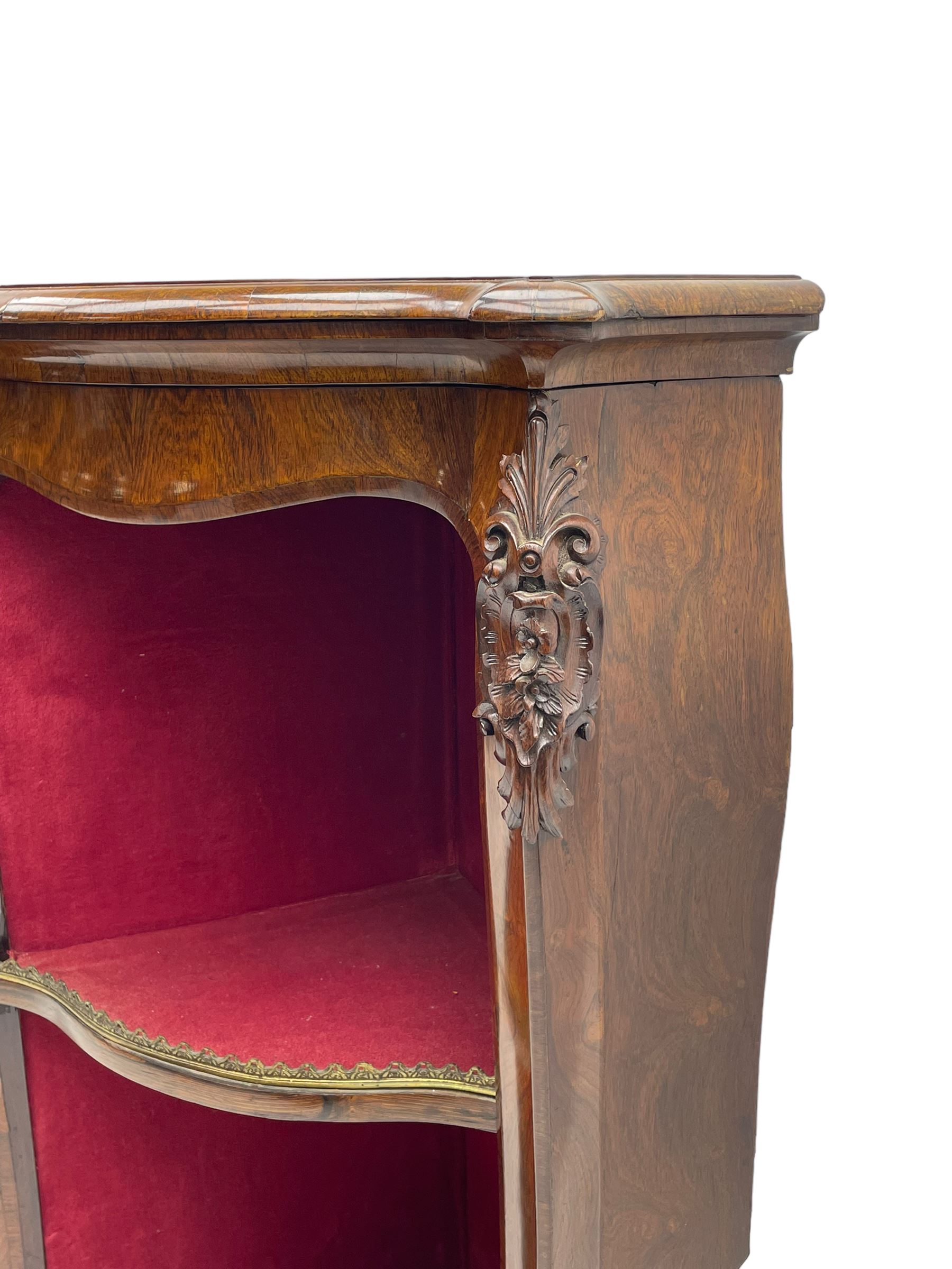 19th century rosewood buffet credenza, bombe form with shaped and moulded top, two central glazed doors with foliate moulded gilt slips, the red fabric-lined interior fitted with a single shelf, flanked by open shelves with raised gilt metal lips, the uprights decorated with shell and flower head carved cartouche mounts, acanthus leaf scroll carved lower mounts, on shaped and moulded plinth base 