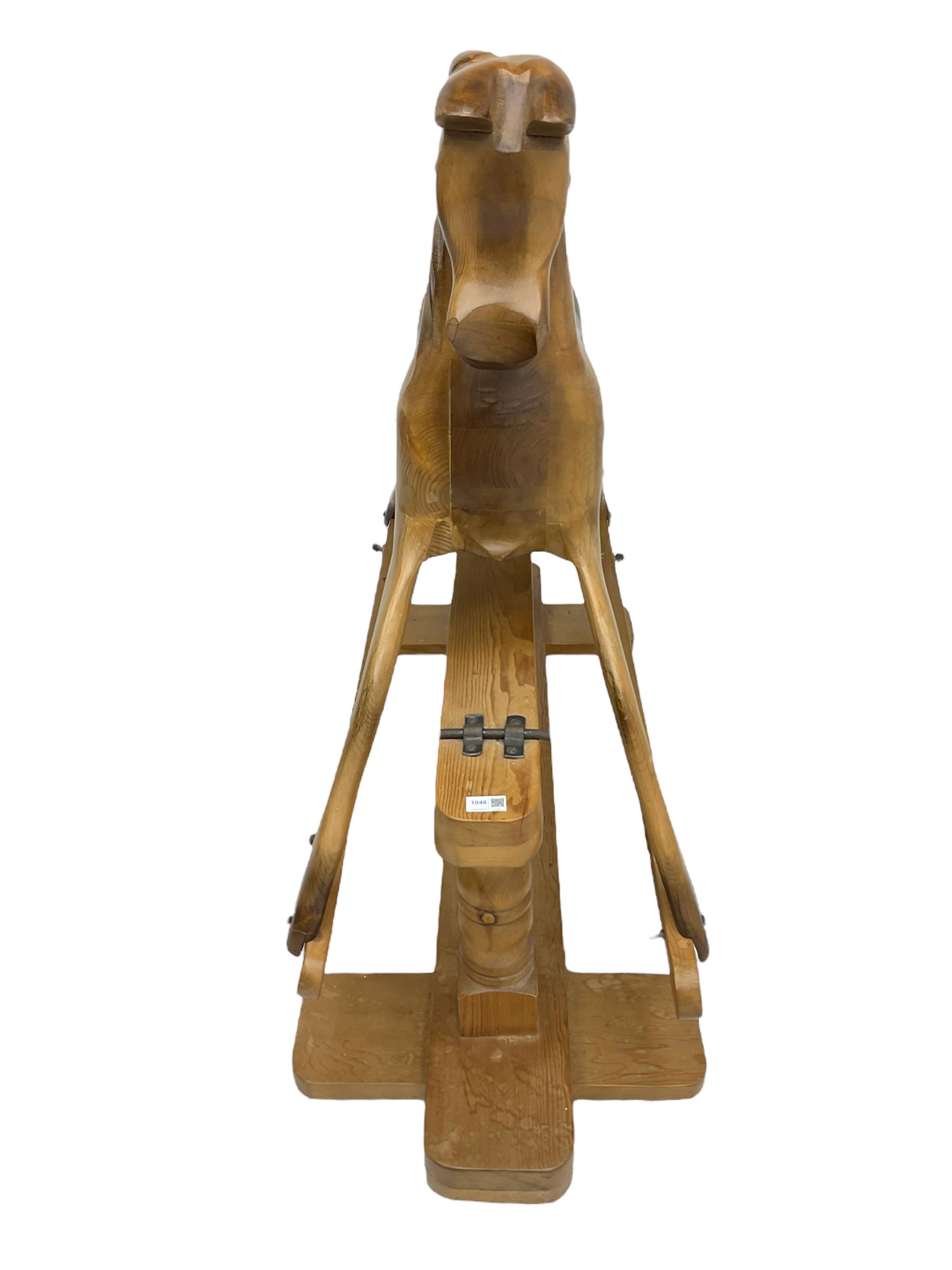 Terry White for White Horses (Hertfordshire 20th century) - Carved pine rocking horse, raised on a pine trestle base