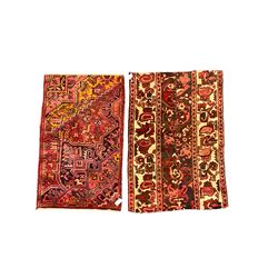 Two Persian crimson ground rugs, decorated with floral and foliate motifs max 137cm x 82cm (2)