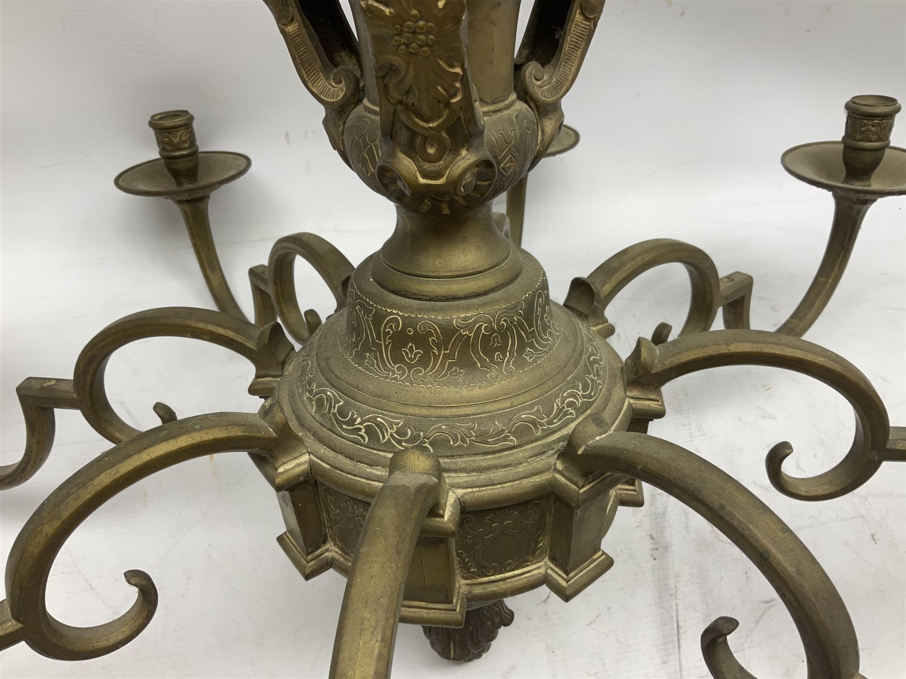 20th century heavy brass eight branch electrolier, detailed with putti masks, approximately H60cm W71cm