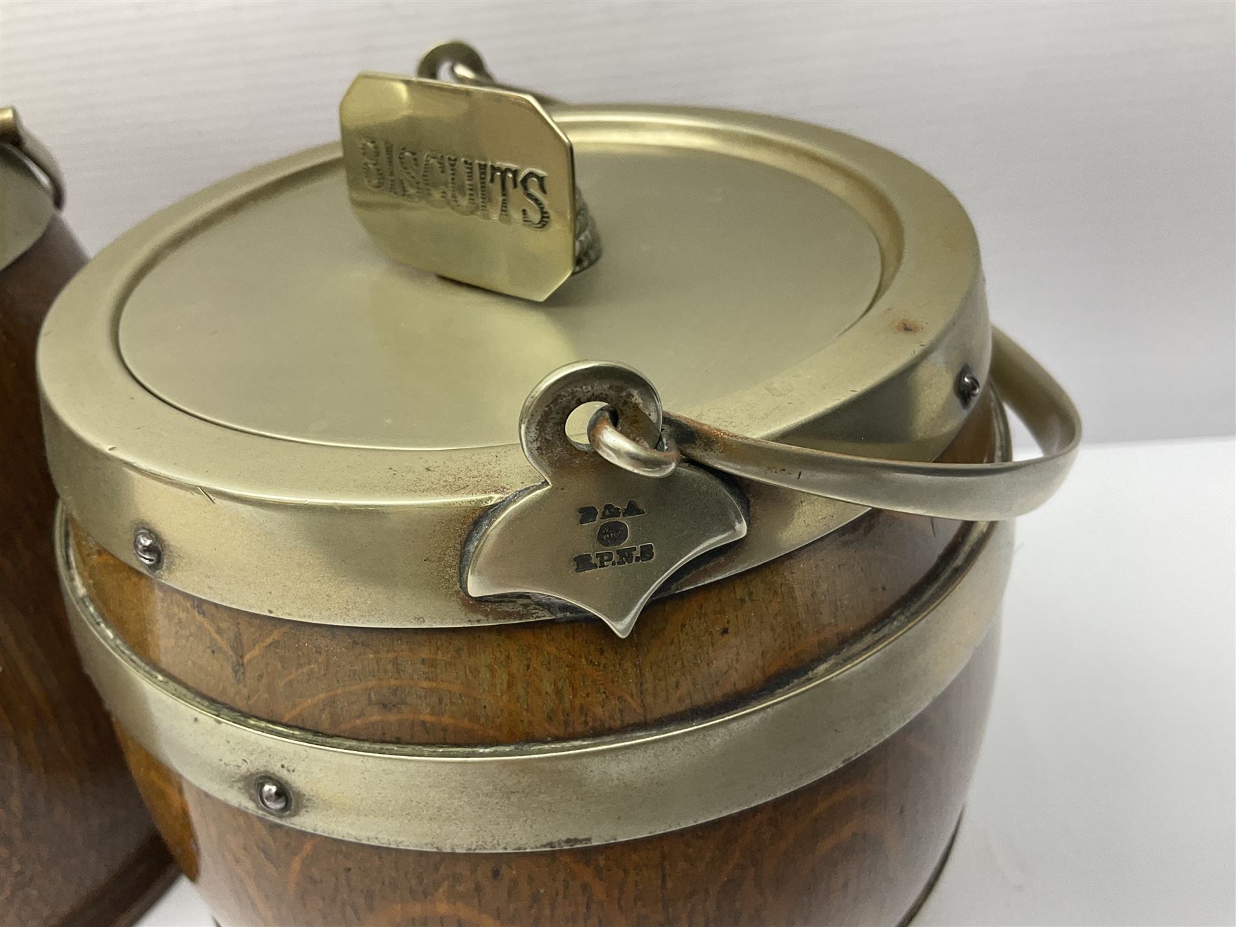 Five early 20th century biscuit barrels with silver-plated mounts, one made from Mahogany from HMS Hindustan