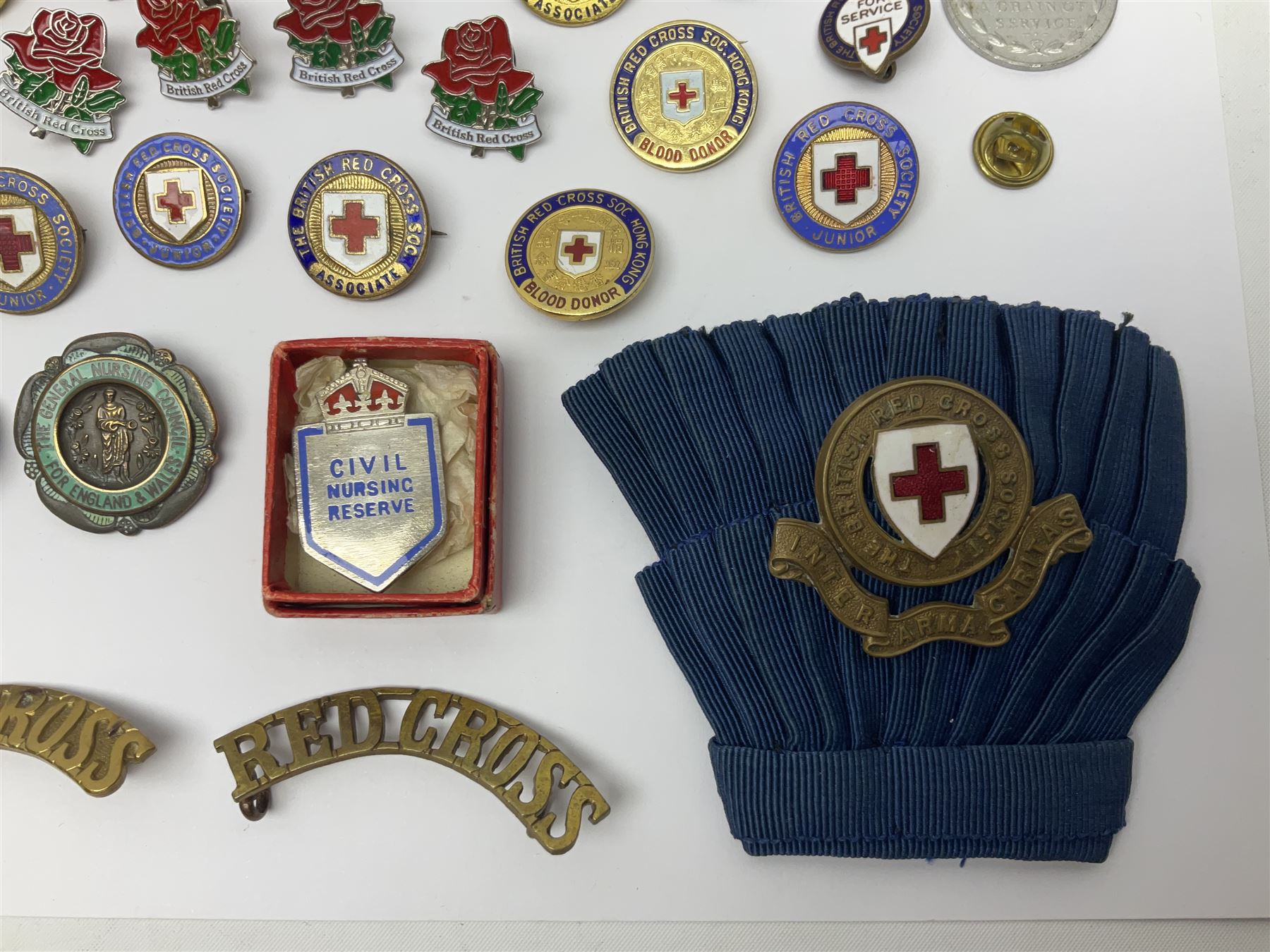 Collection of St John Ambulance enamel and metal badges, together with Red Cross medals and badges