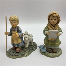 Eight Christmas Hummel figures by Goebel, to include Wintertime Chapel candle holder, Winter Fun, Christmas Morning, Christmas Time and Gingerbread Lane, tallest H21cm