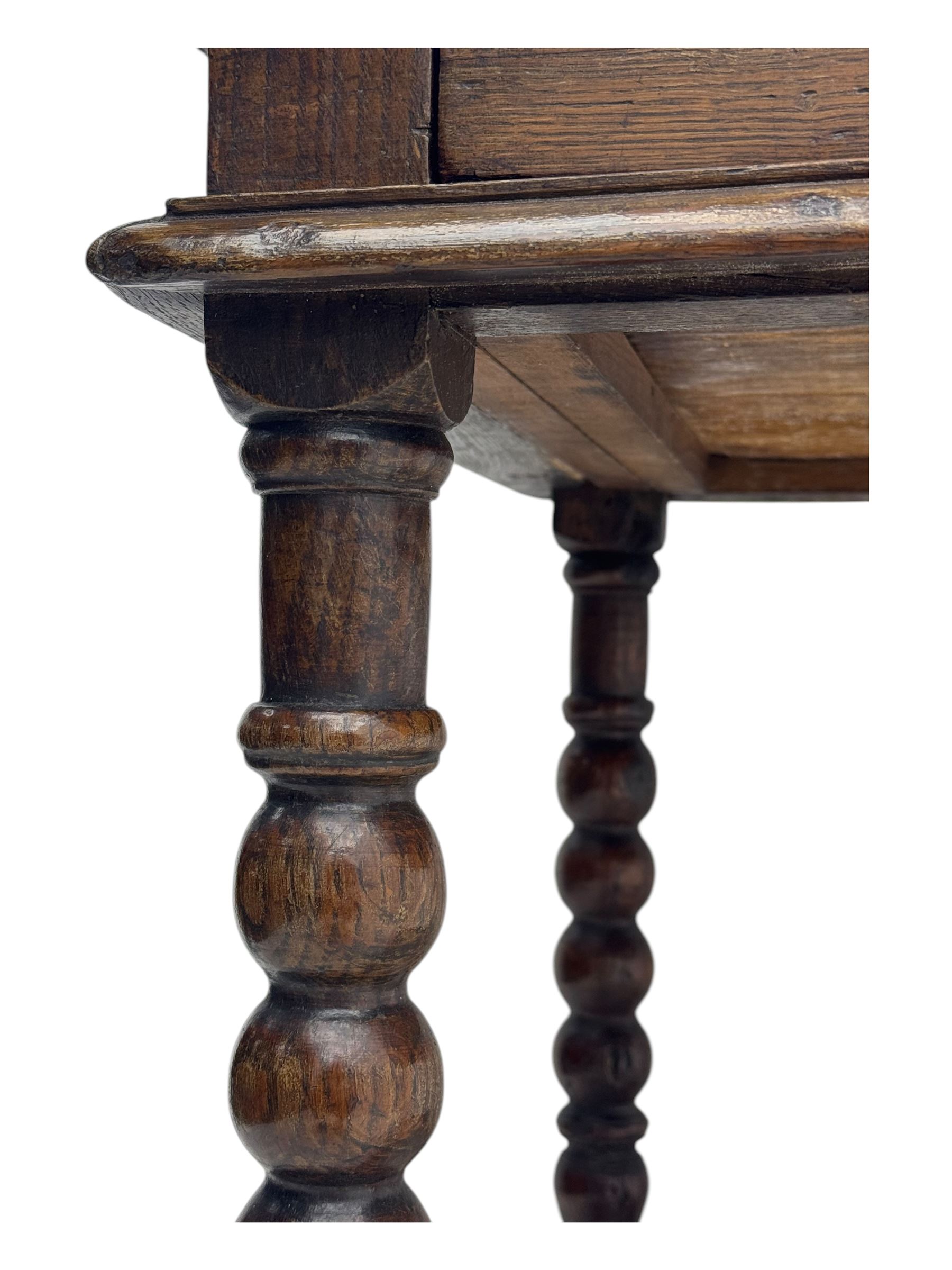 Late Victorian oak side table, rectangular top with moulded edge and frieze drawer with brass handle, raised on turned bulbous supports united by square-section stretchers