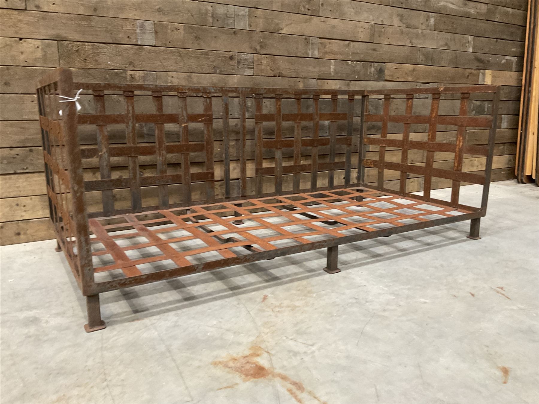 Wrought iron strapwork garden day bed, lattice back and sides