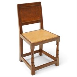 Mouseman side chair- panelled adzed back over tan leather upholstered seat with studwork, on octagonal front supports united by stretchers, each with signature carved mouse, by the workshop of Robert Thompson, Kilburn