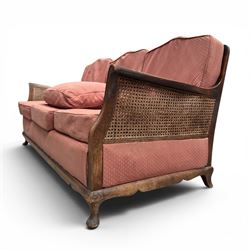 Early 20th century French style bergère conservatory suite, canework back and sides with red upholstered loose seat cushions, on cabriole feet