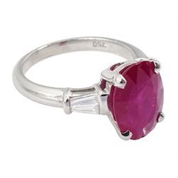 18ct white gold ruby and diamond ring, the oval cut ruby of 4.16 carat, with two tapered baguette cut diamonds set either side, hallmarked