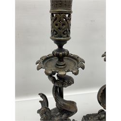 Pair of late 19th/ early 20th century brass candlesticks in the form of dolphins upon a stepped base with Fleur-de-lis design, H32cm 