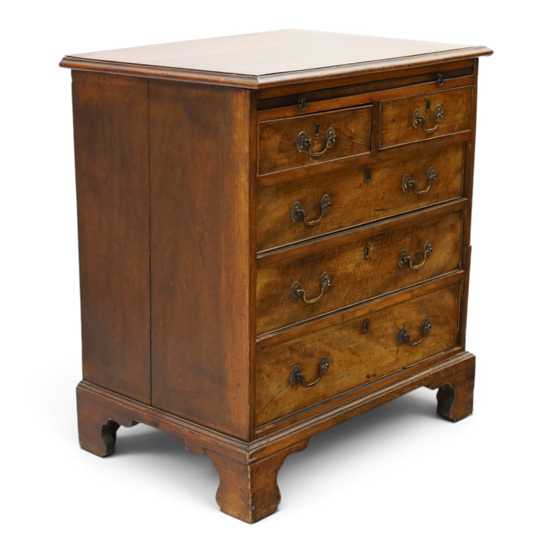 George III mahogany bachelors chest, rectangular top with moulded edge, fitted with brushing slide over two short and three long cock-beaded drawers with brass swan-neck handles, lower moulded edge on bracket feet