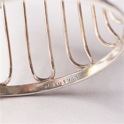 Edwardian pierced silver sugar basket with swing handle and blue glass liner H9cm London 1906 Maker Haseler Bros. and another decorated with floral swags Chester 1912 Maker  (2)