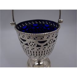 Edwardian silver swing handled sugar basket, with pierced and engraved star and foliate decoration to body, with beaded rim and handle, upon stepped circular base, hallmarked Thomas Hayes, Birmingham 1902, not including handle H10.8cm, with blue glass liner