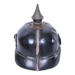 WWI Prussian M1915 Pickelhaube, the black leather skull with removable steel spike finial, steel eagle helmet plate and leather chin strap, one side with a black cockade, the other black and red