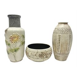  Bretby vase, of baluster form, with fluted and chain link decoration upon an ivory ground, together with a similar Bretby bowl, decorated with a band of roses upon an ivory ground, both with impressed marks beneath, and one other vase, with relief floral decoration and pewter cased rim, tallest H33cm